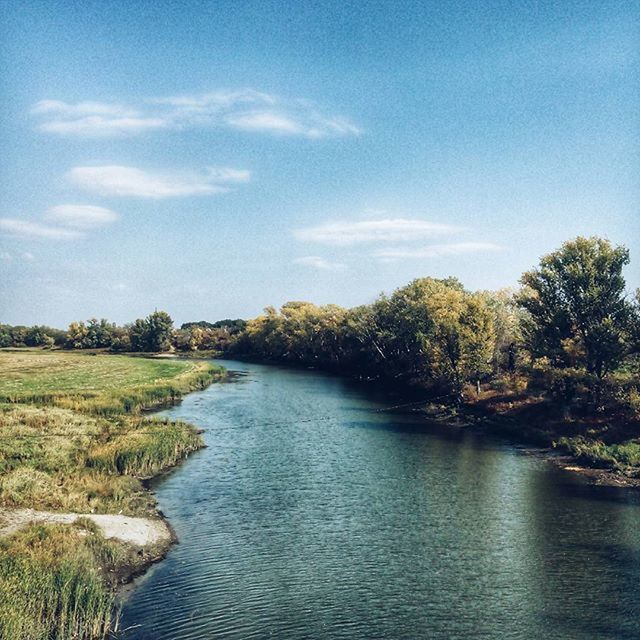 water, tree, sky, tranquility, tranquil scene, scenics, river, nature, beauty in nature, waterfront, blue, growth, cloud - sky, day, cloud, lake, rippled, outdoors, idyllic, sunlight