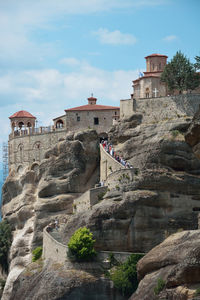 The holy monastery of saint nicholas of anapafsas and people waiting in line to visit it