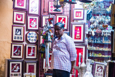 Full length of man standing at store