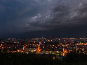 Aerial view of city lit up at night