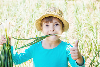 Portrait of young woman holding plant