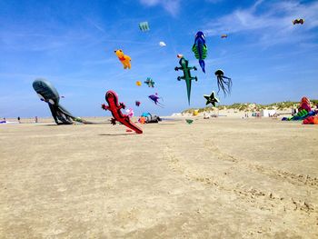 People on beach against sky