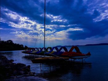 Boat moored on sea against sky