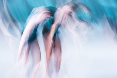 Double exposure of woman dancing