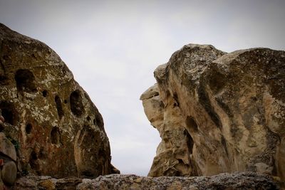 Low angle view of rock formations against sky