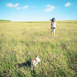 Full length of girl running on grassy field