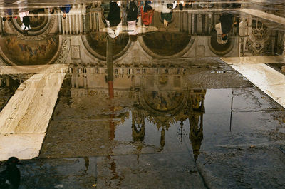 Reflection of building in puddle