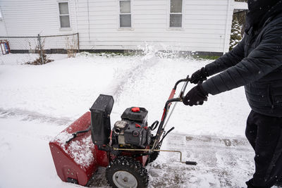 Snow blower is working hard to clear the fresh snow fall from your driveway after a big snow storm