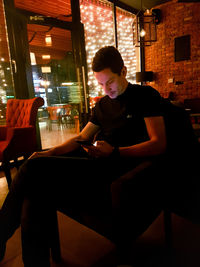 Woman sitting on table in restaurant