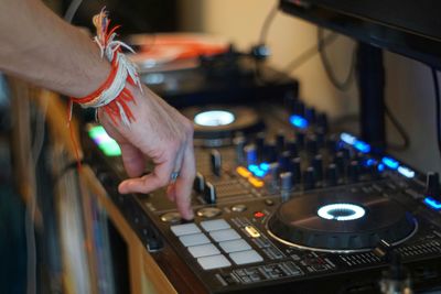 Cropped hand of man mixing music at recording studio