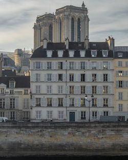 Gothic notre-dame-de-paris cathedral with haussmannian facades and the seine