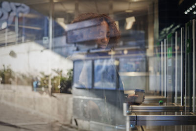 Woman at ticket barrier at train station