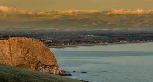 Scenic view of sea and mountains against sky