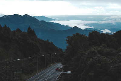 High angle view of road by trees against sky