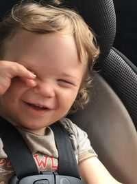 Portrait of cute girl sitting in car