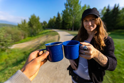 Portrait of young woman drinking coffee