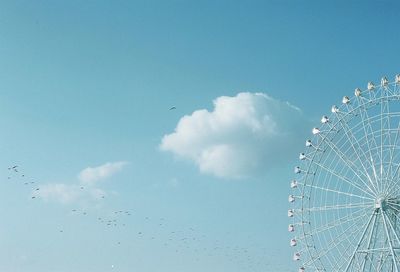 Low angle view of giant ferris wheel against sky