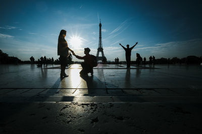 Silhouette of people on city at sunset