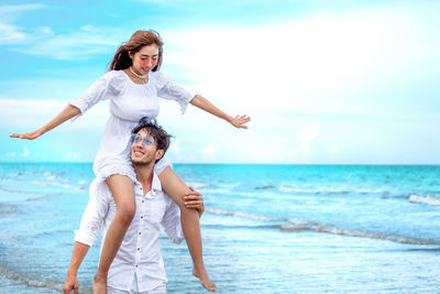 Full length of woman on beach against sky