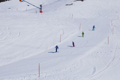 High angle view of people skiing on snowcapped mountain