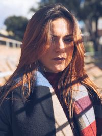 Close-up portrait of young woman standing outdoors