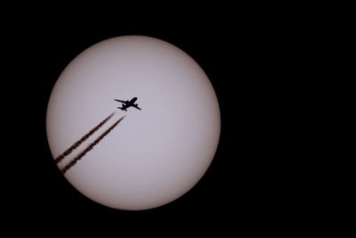 Low angle view of airplane over the background