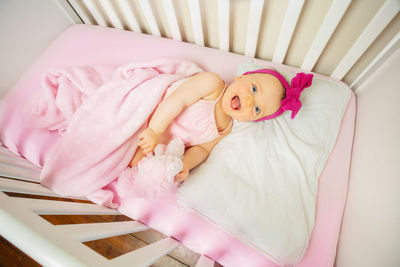 High angle view of baby boy sleeping on bed at home