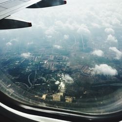 Aerial view of cityscape seen through airplane window