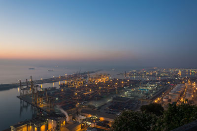 High angle view of illuminated buildings against sky during sunset