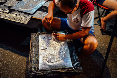 High angle view of man sitting on table