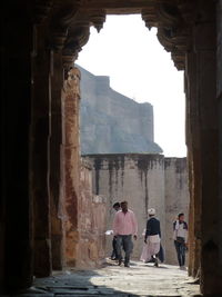 Rear view of people walking in historical building