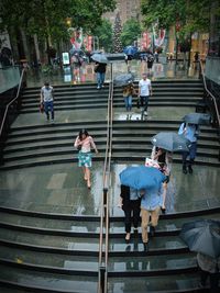 High angle view of people walking on staircase