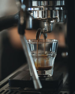 Close-up of coffee pouring in glass