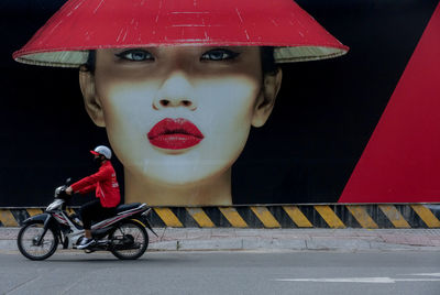 Side view of man riding motorcycle on road