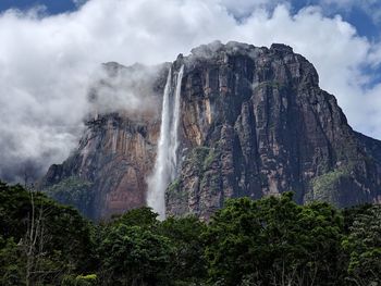 Low angle view of waterfall against sky