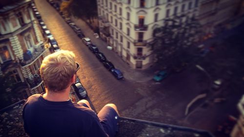 Rear view of man standing on city street