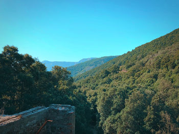 Scenic view of mountains against clear blue sky