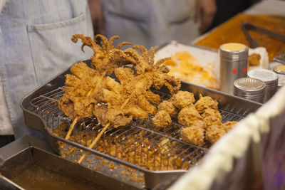 High angle view of fresh fried food on metal grate