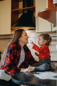 Side view of women sitting at home