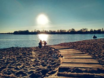 Scenic view of beach against sky during sunset