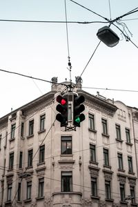 Low angle view of street light against building