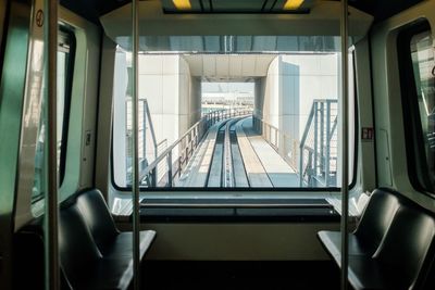 View of railroad track through interior of cabin of train