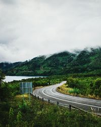 Road by mountain against sky