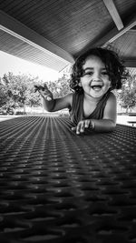 Portrait of smiling girl sitting outdoors`