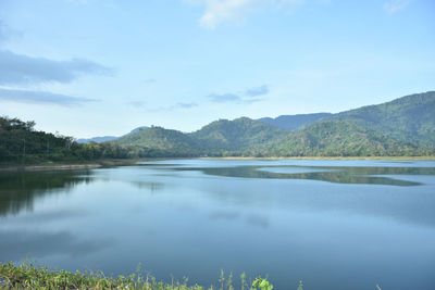 Scenic view of lake and mountains against sky