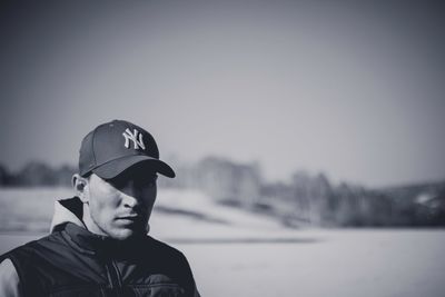 Portrait of young man standing in snow