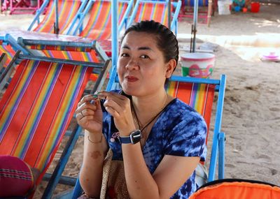 Portrait of woman sitting outdoors