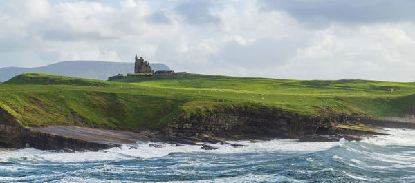 Scenic view of sea and buildings against sky