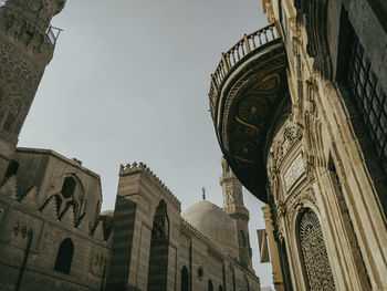 Low angle view of historic cairo building with intricate design and detail against sky 