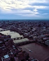 Aerial view of city against cloudy sky